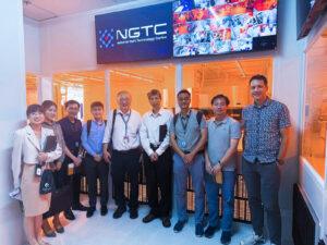 Group photo of NSTIC (GaN), MediaTek, and EDB representatives during a facility visit at the NSTIC (GaN) cleanroom lobby.